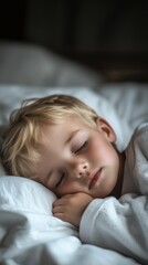 Blond little boy sleeping in bed. lying asleep by night in bedroom. Vertical photo (9:16)