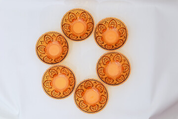 Vintage peach colored dessert bowls arranged in a circle on white fabric