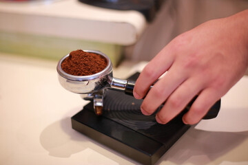 The coffee is weighed in the filter and the digital scale to prepare a cappuccino