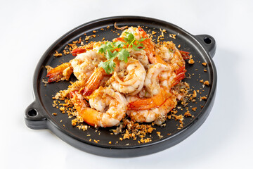 Fried shrimp with garlic and pepper on black plate - seafood style