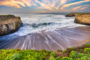 Coastal cliffs along California's Highway 1 in California. Rugged ocean rocks, crashing waves, and...