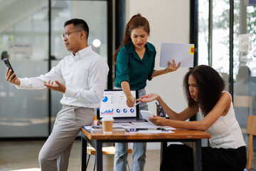 Fototapeta premium Team of business Asian work with documents tax laptop computer in office. Sad, unhappy, Worried, Depression, or employee life stress concept 