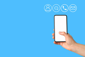 A hand is holding a smartphone ready for communication with various icons nearby