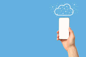 A person with a smartphone displaying a cloud icon on a blue background