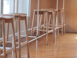 wooden chair on the table. Set High of wooden chair at the counter bar. Famous interior design in coffee shop.