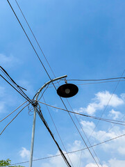 Silhouette of a Street Lamp Against a Bright Blue Morning Sky