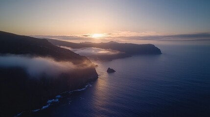 Fototapeta premium Tranquil Ocean Surface at Sunrise with Misty Coastal Landscape