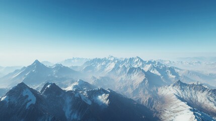 Fototapeta premium Panoramic view of snow-covered mountain range under clear blue sky evokes serenity and vastness