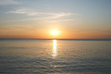 A boat and a beautiful sunset sky at the sea