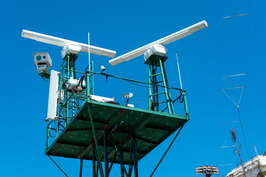 Radar detection system of watercraft against blue sky.