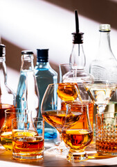 Strong hard alcoholic drinks, spirits, liqueurs, distillates, whiskey and others in glasses and...