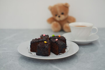 several pieces of moist chocolate cake served on a white plate