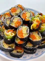 Korean Seaweed Rice Rolls or Kimbap Korean dish made from cooked rice vegetables, meats that are rolled in seaweed, BBQ Kimbap Korean food Isolate on white with clipping path.