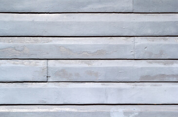 Light blue weathered wooden planks siding cladding close-up abstract textured background