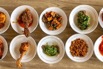 Top view of typical Minangkabau cuisine served on plates