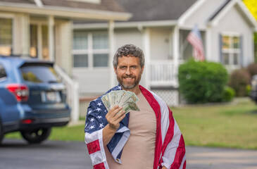 Man with American flag and dollar money. Inflation concept. American tax policy. Hispanic man and...