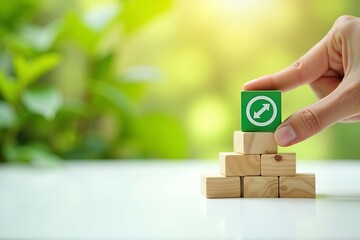 Business strategy growth success building blocks with arrows on green block and hand placing it on top