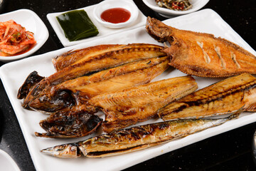 Various grilled fish on a white plate