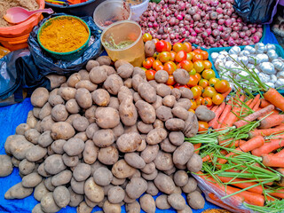Vegetables and spices are sold in traditional markets, such as shallots, tomatoes, potatoes, carrots, limes, and various ground cooking spices.