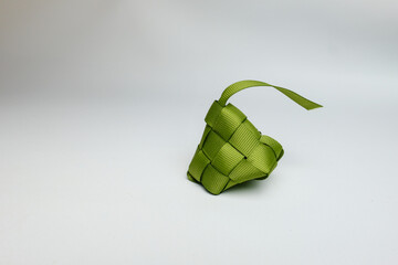 Green Ribbon Ketupat Decoration on White Background