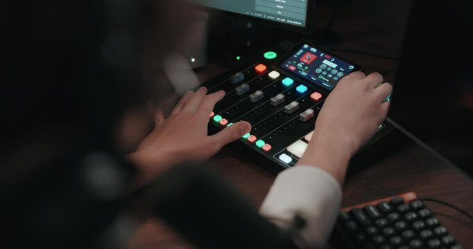 Video game live streamer adjusting microphone, camera, and stream 