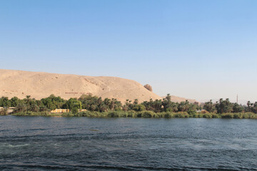 Fototapeta premium Landscape of the magical blue Nile River in upper Egypt with the signboard-Welcome to Aswan