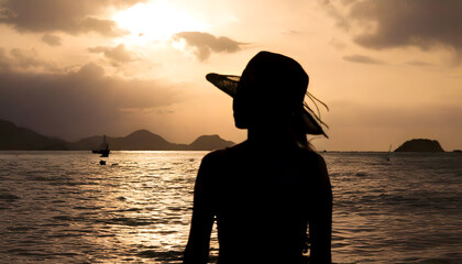 Silhouette of people by the Seaside at Sunset with a Pier in the Distance