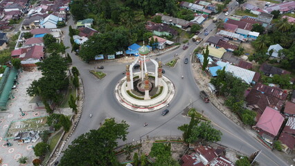 Rantau, Indonesia, 20 Desember 2024, Aerial view of city square roundabout with traffic activity...