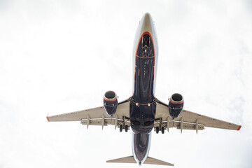 A passenger plane flying in the clouds in the sky