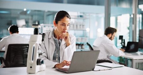 Thinking, laptop and reading with woman in laboratory for clinical trail, reflection and research. Medical journal report, vision and pharmacy drug development with person for healthcare and science