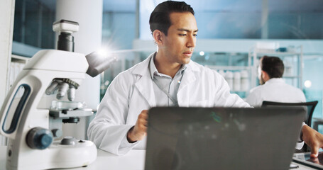 Microscope, science and laptop with man in laboratory for dna sample, forensics investigation and...