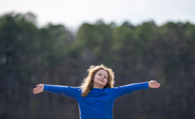 Child in a daydream. Carefree childhood in nature. Dreamy kid. Thoughtful child. Little child dreamer. Young mind full of imagination. Blonde child thinking. Kids freedom. Calm and peaceful childhood.