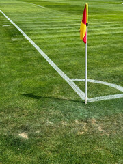 Fototapeta premium Football flags on the corner of the green field of the stadium
