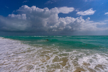 Ocean waves and sand, summer coastline background. Stormy sea waves. Summer sea beach wave. Foamy ocean waves. Summer ocean breeze. Dreamy summer beach background. Ocean splash waves.