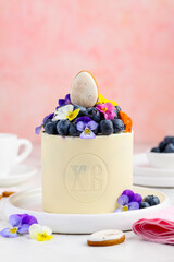Easter cottage cheese paskha with blueberries in a white chocolate body decorated with pansy flowers. Traditional Easter curd dessert. Selective focus