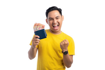 Excited young Asian man holding cash in wallet and raising his fist isolated on transparent...