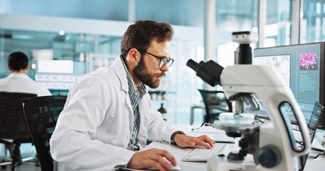 Microscope, computer and research with man in laboratory for tissue sample, cancer cure and...