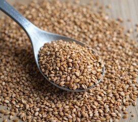 Obraz premium Spoonful of Barley Grains Close Up on Wooden Background for Food Photography