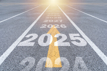 New year 2025 or straight forward concept. Text 2025, 2026, 2027, 2028 written on the road in the...