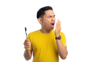 Handsome young Asian man checking his breath with his hand, bad smell from mouth, holding toothbrush isolated on transparent background