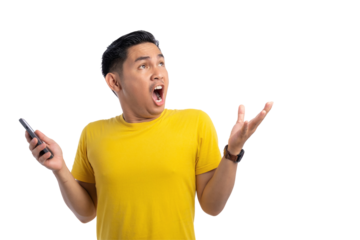 Excited young Asian man holding mobile phone and looking up with shocked expression isolated on transparent background
