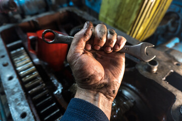 repair of an old blue tractor in a vintage garage, dismantling and installation of a gearbox, replacement of bearings