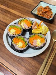 Korean Seaweed Rice Rolls or Kimbap Korean dish made from cooked rice vegetables, meats that are rolled in seaweed, BBQ Kimbap Korean food Isolate on white with clipping path.