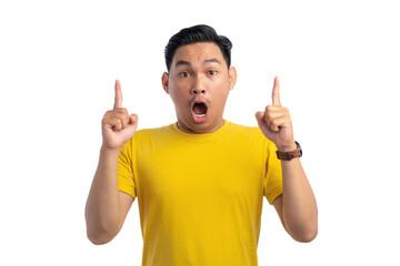 Happy young Asian man pointing with his index finger at top copy space for advertising text...
