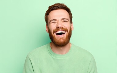 A man with highly amused laughing face, pastel light green background