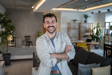 Architect smiling with crossed arms in modern apartment