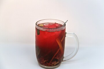 Chilled version of Wedang Uwuh, a traditional Indonesian herbal drink made with ginger, cinnamon, cloves, and lemongrass. Served cold with a vibrant red color and refreshing taste.