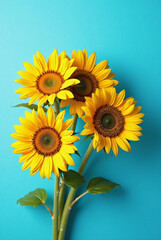 Obraz premium A bouquet of sunflowers on a bright blue background. Father's Day image. Expressing gratitude.