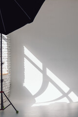 Clear white cyclorama. Light background with with professional lighting equipment. Plain wall empty photo studio. Vertical photo.