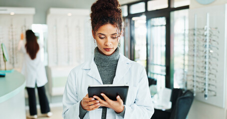 Tablet, woman and optometrist in shop for vision, eyecare or wellness report online. Reading, research and female optician with digital technology for checking ophthalmology appointment in store.